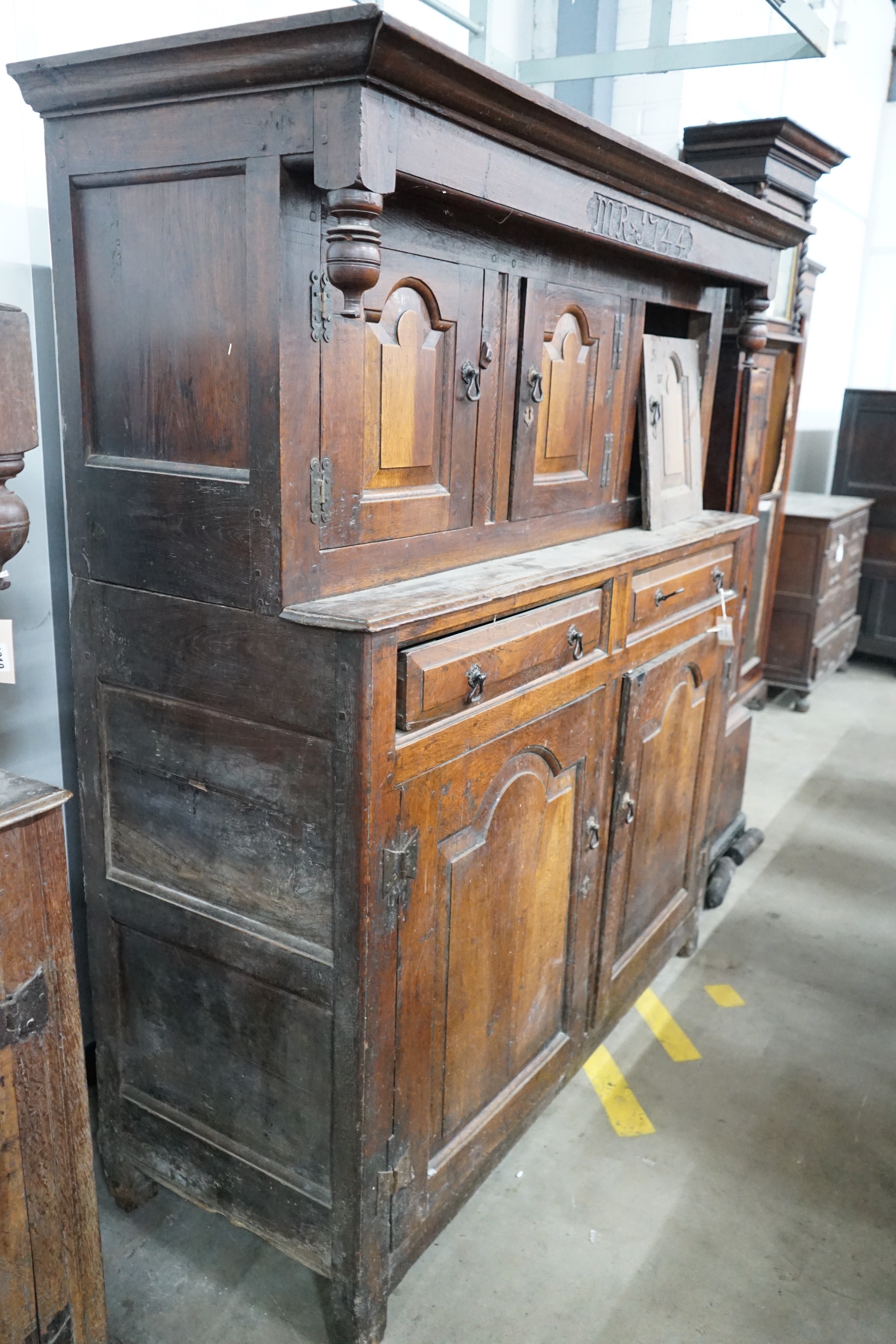 A mid 18th century oak court cupboard, initialled MR and dated 1744, width 155cm, depth 57cm, height 181cm